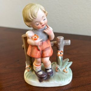 Vintage Arnart girl against a fence porcelain figurine